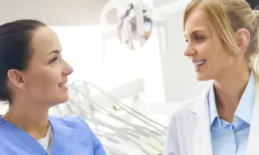 Dental Assistant with Associate Degree Consulting with Dentist
